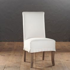 a white chair sitting on top of a wooden floor