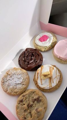 a box filled with different types of cookies