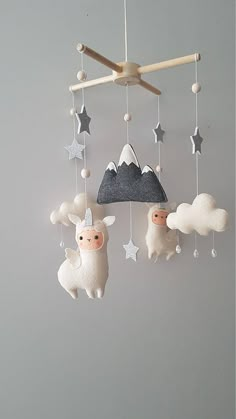 a mobile with sheep and stars hanging from it's sides