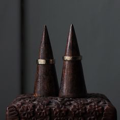 two small wooden cones sitting on top of each other