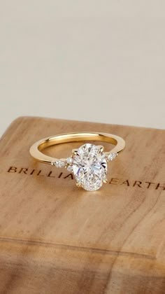 a diamond ring sitting on top of a wooden box