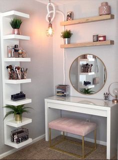 a white desk topped with a mirror next to a shelf filled with books and plants