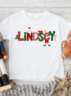 Custom Christmas T-shirt for Girls, Personalized Christmas Name Shirt, Fun Alphabet Custom Name Christmas Shirt, Kids Personalized Christmas Shirt So cute for keeping the kids cute at Christmas! Set them apart with a soft t-shirt customized with their name in this fun Christmas Alphabet. Shirts are classic white, short sleeve. Sizes from Baby to Youth Classic white, short sleeve shirt Sublimated Design Adorable gift for kids to wear on Christmas morning or at school parties! Christmas Shirt With Name, Christmas Initial Shirts, Vinyl Christmas Shirt Kids Zazzle, Christmas T-shirt With Name, Green Christmas T-shirt With Letter Print, Kids Chrismtas Shirt, Personalized Christmas Shirts, Christmas Shirts For Kids, Christmas Names