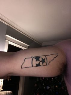 a man's arm with an outline of the state of indiana and stars on it