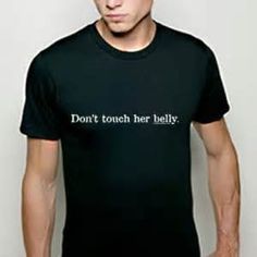 a man wearing a black shirt with the words don't touch her belly on it