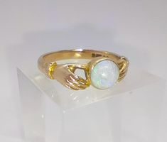 A vintage fully hallmarked 9ct gold opal ring - hands holding / fade ring. Beautiful quality throughout set with a magically colourful opal. Perfect condition  Fully hallmarked for 9ct gold UK ring size O, US size 7 1/4 The front of the ring measures 0.7cm at the widest point and sits at 0.5cm off the finger Antique 14k Gold Hallmarked Opal Ring, Antique Hallmarked Opal Ring, Luxury Gold Opal Ring Hallmarked, 14k Gold Multi-stone Opal Ring, Vintage 14k Gold Multi-stone Opal Ring, Gold Opal Ring, Hands Holding, Opal Ring Gold, Opal Ring