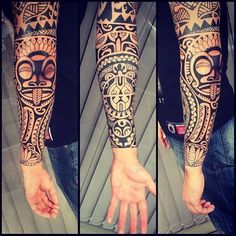 the arm is covered in tattoos and has an image of a mask on it's arm