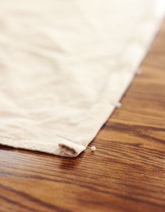 a piece of white paper sitting on top of a wooden floor