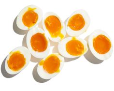 an overhead view of hard boiled eggs on a white surface