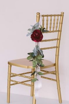 a gold chair with a rose on it