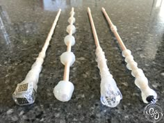 four toothbrushes lined up on a counter top with one being used as an appliance