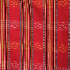 a red and yellow striped fabric with small white dots on the bottom half of it