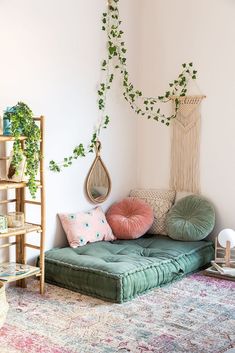 a living room filled with lots of furniture and plants on top of the wall next to a rug