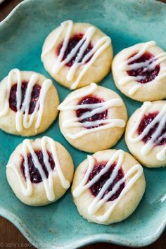 small cookies with white icing are on a blue plate, ready to be eaten