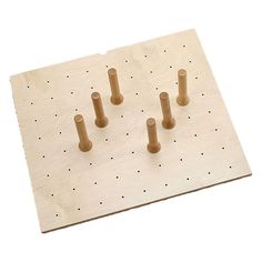 a wooden peg board with four pegs on it