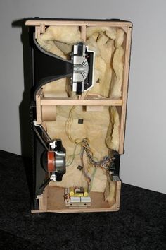 the inside of a wooden box with wires in it