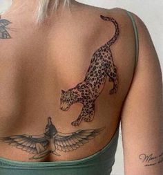 the back of a woman's body with tattoos on her upper and lower half