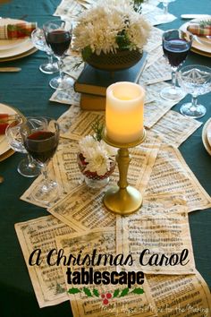 a table topped with lots of paper and candles next to wine glasses on top of each other