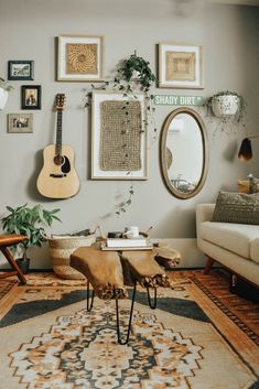 a living room filled with furniture and pictures hanging on the wall above a coffee table