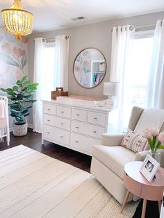 a baby's room is decorated in pink and white