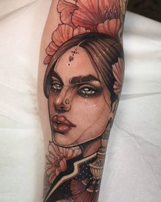 a woman's face with flowers on her head is shown in this tattoo design