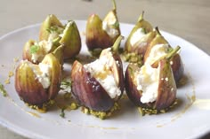 figs with goat cheese and pistachio on a white plate