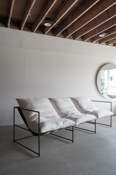 a white couch sitting in front of a round window