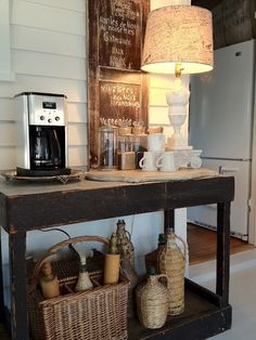 a table with baskets and coffee cups on it in front of a wall mounted sign