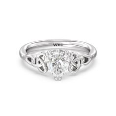 a white gold engagement ring with an oval cut diamond in the center and two intertwined hearts