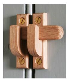 a close up of a wooden door handle on a metal door frame with two knobs