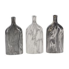 three marbled vases sitting next to each other on a white background, one is gray and the other is black