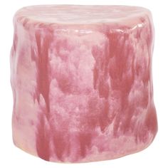 a pink and white ceramic stool with trees on it's sides, against a white background