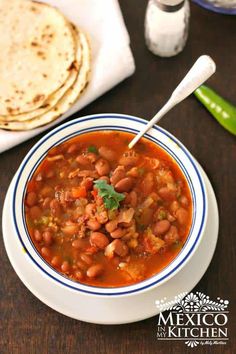 a bowl of beans and tortilla soup on a table