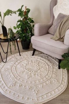 a living room area with a chair, rug and potted plants