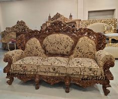 an ornately decorated couch in a room with other furniture and accessories on the floor