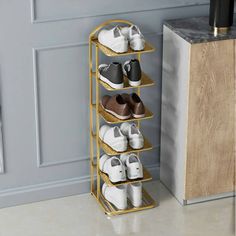 a gold shoe rack with several pairs of shoes on it