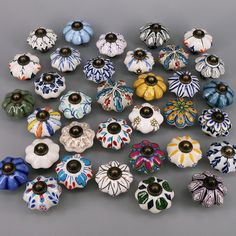 an assortment of colorful ceramic knobs on a gray surface