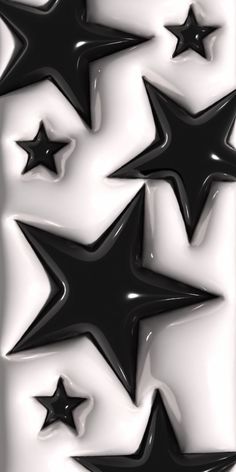 black and white stars are arranged in the shape of an abstract pattern on a wall