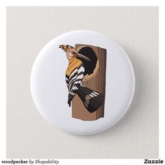 a white button with a bird on it's back and the words woodpecker by shoppilly