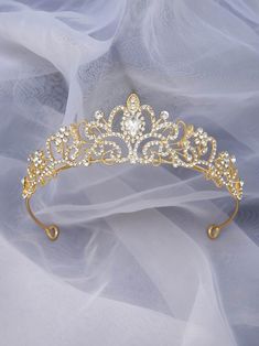 a gold tiara with crystal stones on it