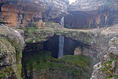 a large waterfall in the middle of a canyon