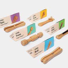 six wooden toothbrushes are displayed in front of each other with labels on them