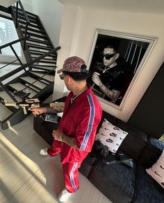 a man standing in front of a stair case next to a couch and coffee table