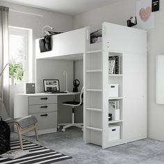 a white loft bed sitting in a bedroom next to a desk and computer chair on top of a rug