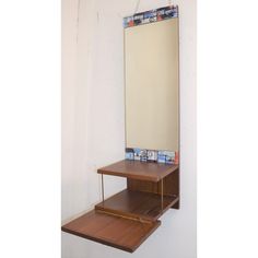 a mirror sitting on top of a wooden shelf