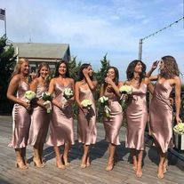 a group of women standing on top of a wooden deck