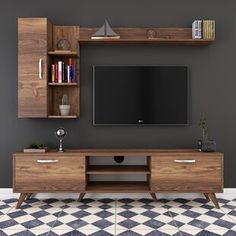 an entertainment center with a flat screen tv mounted on it's side, in front of a gray wall