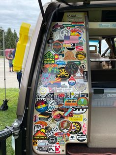 an open car door with many stickers on it