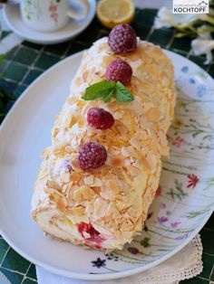 a pastry with raspberries and almonds on a plate