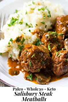 meatballs, mashed potatoes and gravy on a plate with a fork